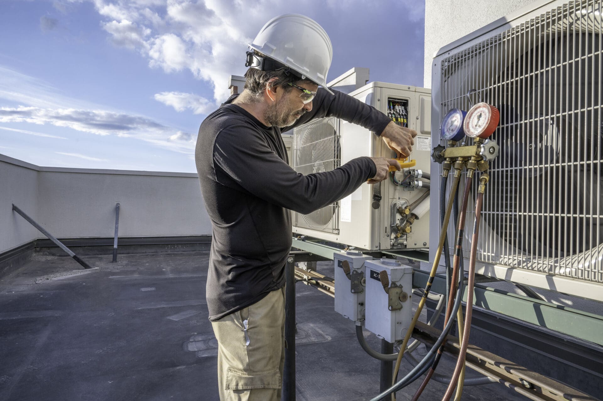HVAC technician hooking up amp clamp